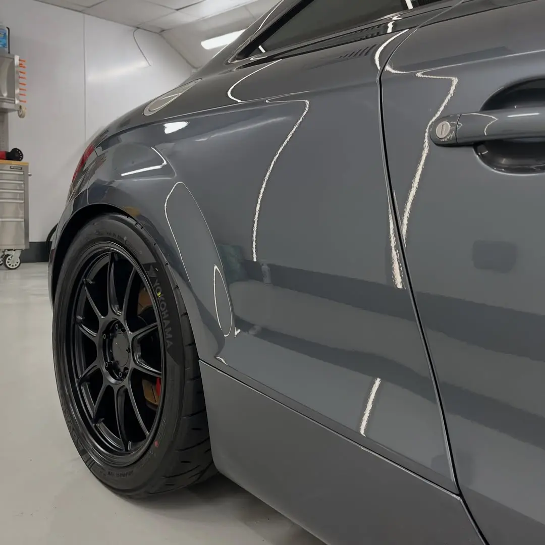 Glossy grey Audi TT paintwork under the valet bay inspection lighting
