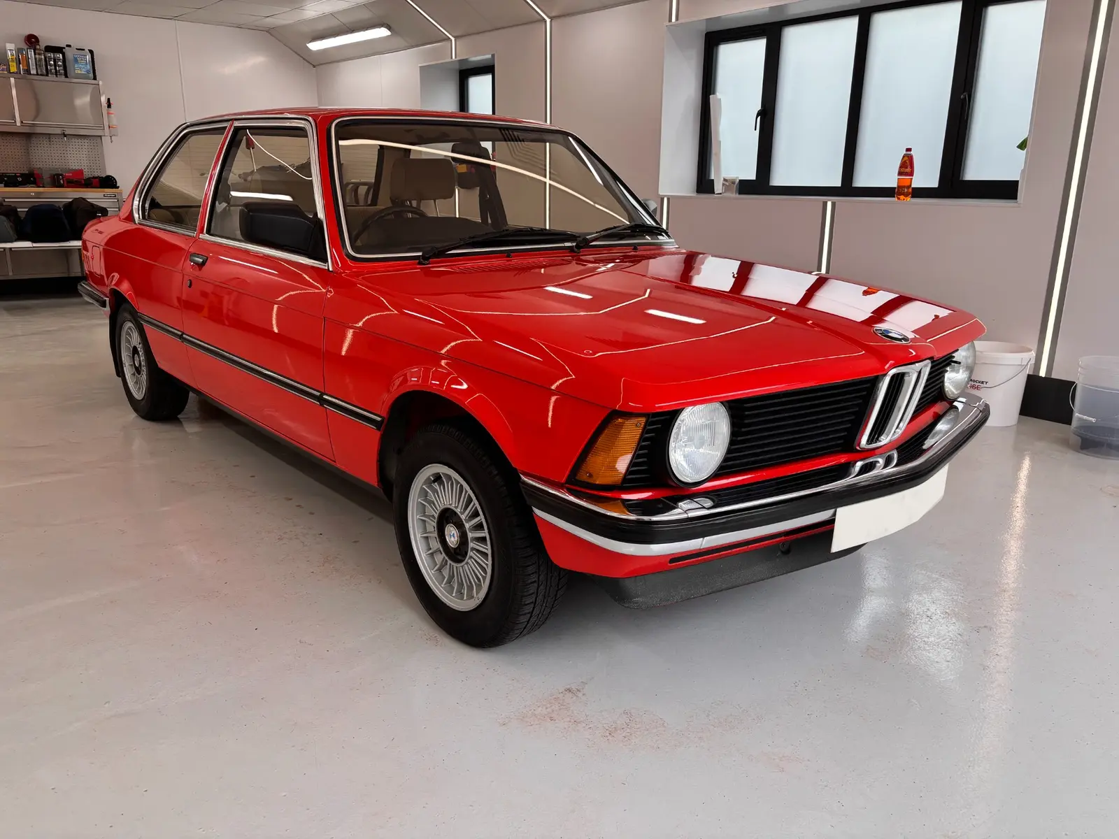 BMW E21 restoration detail showing the corrected red paint finish