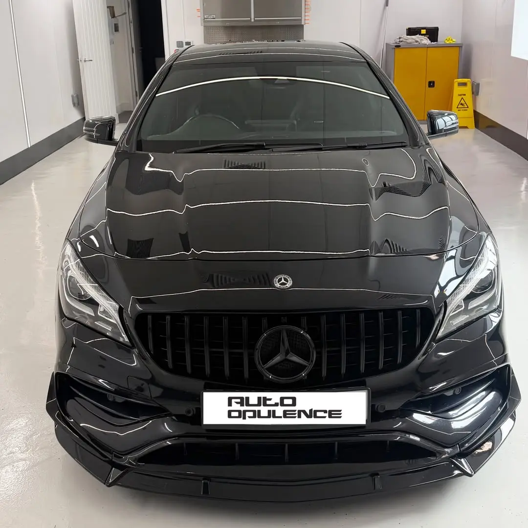 Front view of the glossy Mercedes CLA45 inside the Auto Opulence detailing studio